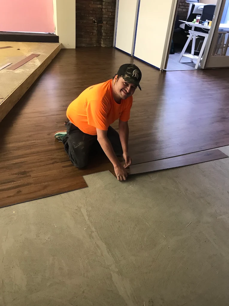 One of our installers setting wood-look planks. Clean seams and a flat subfloor are what keep a winter floor tight.