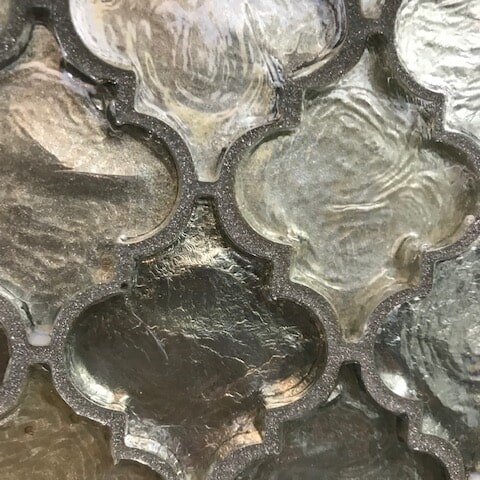 Backsplash is Glazzio glass Dentelle in April Shower with Bostik dimension Sliver grout adds a subtle sparkle